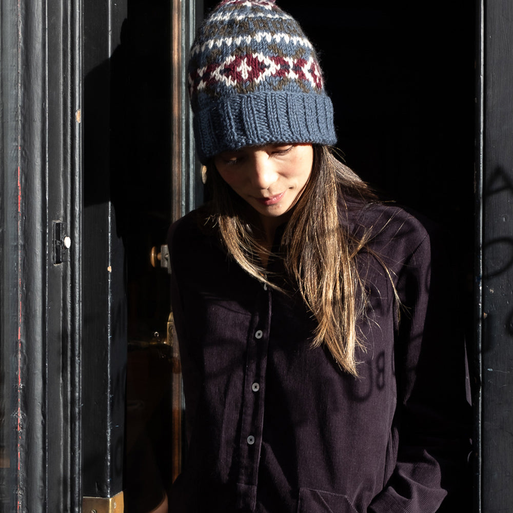 
                      
                        Fern Fair Isle Bobble Hat in Blue
                      
                    